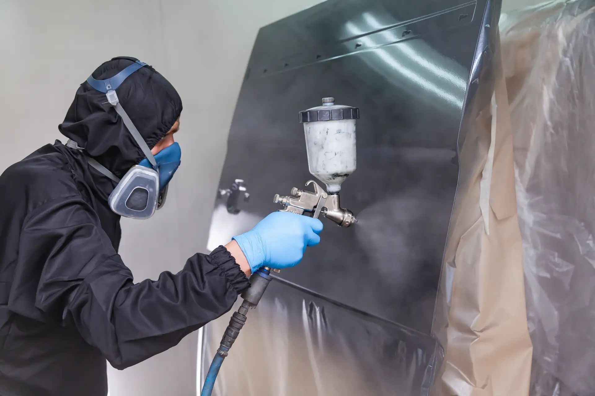 A-Male-Worker-In-Jumpsuit-And--paint-car-body